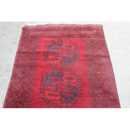 19 - Afghan rug of four central medallions and multiple borders, 226 x 115cm