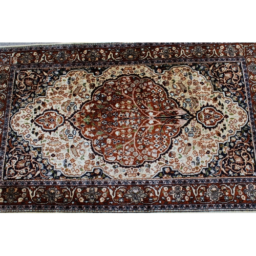 20 - Indo Persian silk style rug with a lobed floral medallion on an ivory ground, in shades of beige, ta... 