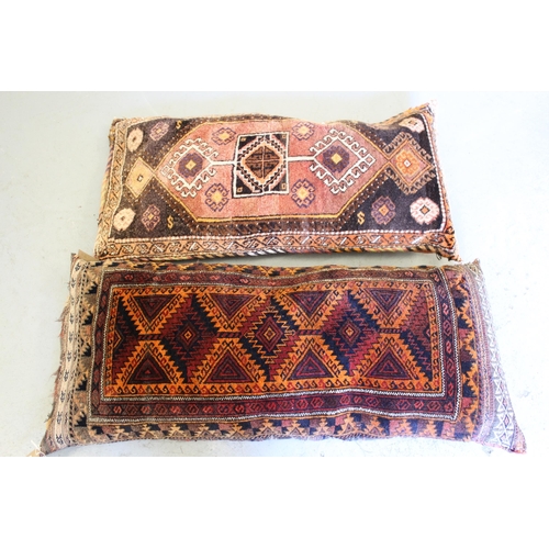 21 - Two carpet / Kelim cushions, each approximately 1m x 50cm