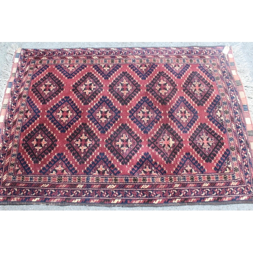 26 - Belouch rug with an all-over hooked medallion design on a plum ground with borders, 140cm x 1m