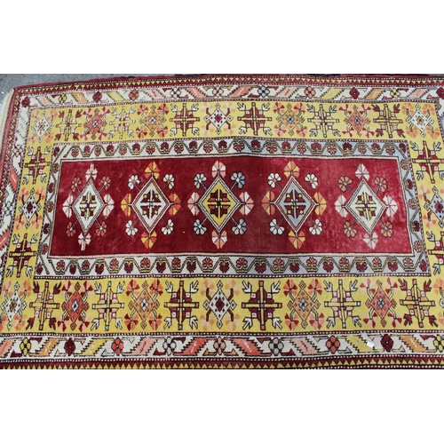 28 - Turkish rug with five central medallions on a rose ground with wide borders in Caucasian style, 193 ... 