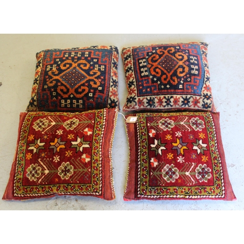 29 - Group of four carpet / Kelim cushions, each 45cm square approximately