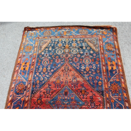 30 - Hamadan rug with a medallion and all-over stylised design in shades of red, blue and orange, 204 x 1... 