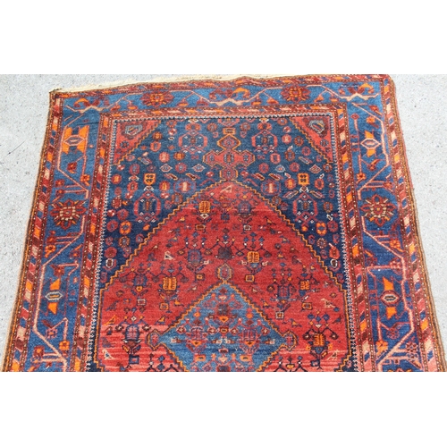 30 - Hamadan rug with a medallion and all-over stylised design in shades of red, blue and orange, 204 x 1... 