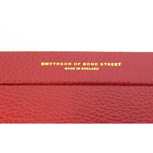 60 - Smythson of Bond Street, red leather square photograph frame on stand, 19cm square