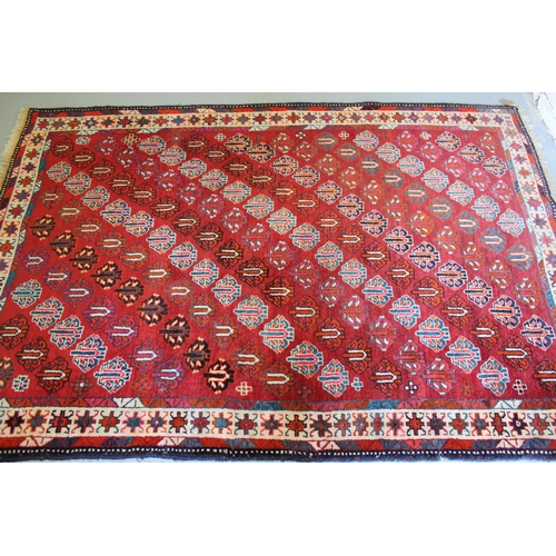 7 - Turkish Caucasian pattern rug on red ground, 212 x 148cm