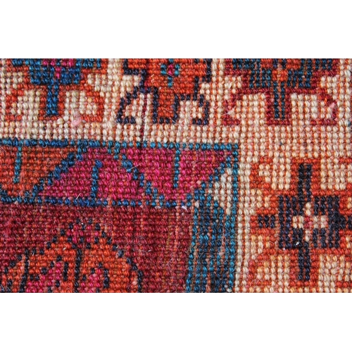 7 - Turkish Caucasian pattern rug on red ground, 212 x 148cm