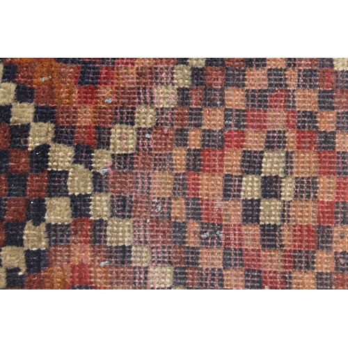 9 - Two small Afghan rugs on red ground, 62 x 45cm