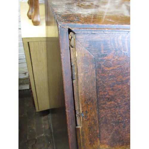 1910 - George III oak bureau, the fall front above an unusual arrangement of short and long drawers on brac... 