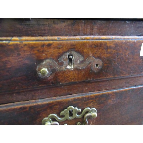 1910 - George III oak bureau, the fall front above an unusual arrangement of short and long drawers on brac... 