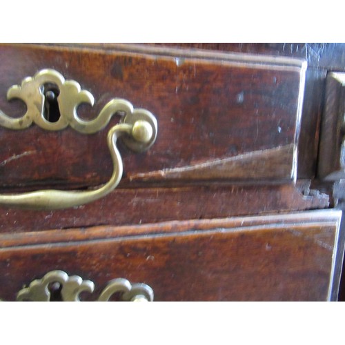 1910 - George III oak bureau, the fall front above an unusual arrangement of short and long drawers on brac... 