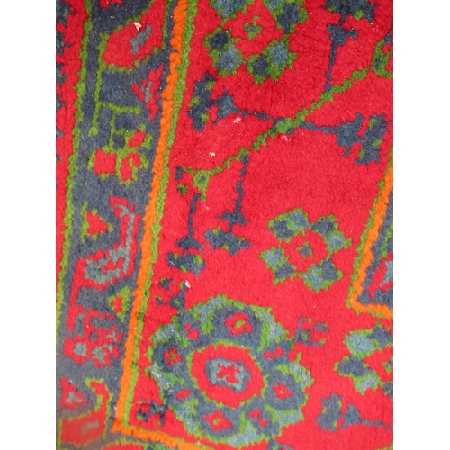 16 - Large Turkish carpet with Ushak design on a red ground with borders, 4m x 3m