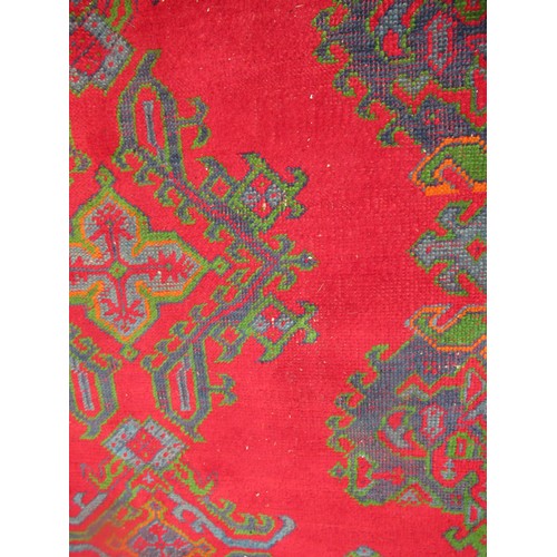 16 - Large Turkish carpet with Ushak design on a red ground with borders, 4m x 3m