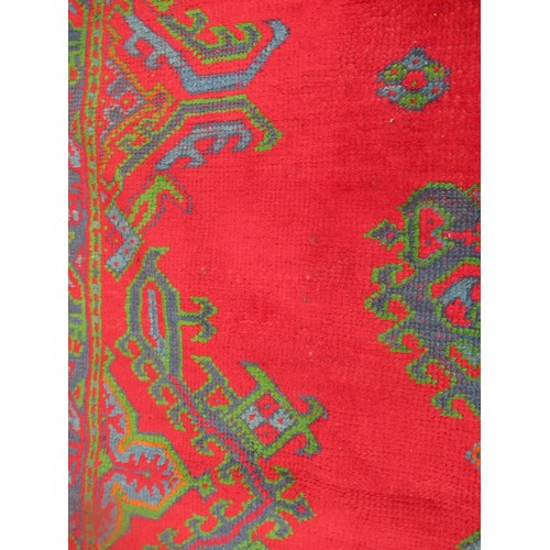 16 - Large Turkish carpet with Ushak design on a red ground with borders, 4m x 3m