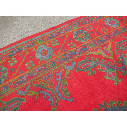 16 - Large Turkish carpet with Ushak design on a red ground with borders, 4m x 3m