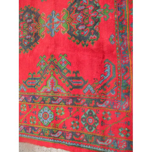 16 - Large Turkish carpet with Ushak design on a red ground with borders, 4m x 3m