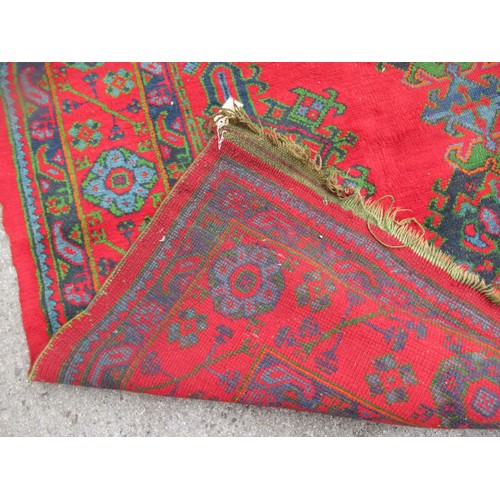 16 - Large Turkish carpet with Ushak design on a red ground with borders, 4m x 3m