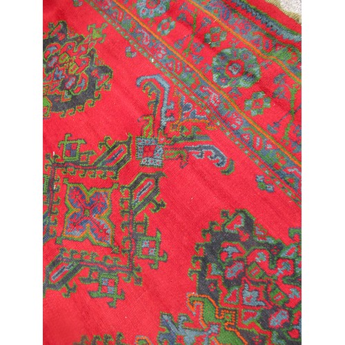 16 - Large Turkish carpet with Ushak design on a red ground with borders, 4m x 3m