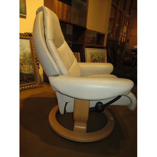 1830 - Modern Stressless cream leather upholstered swivel armchair, together with a matching footstool