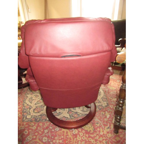 1855 - Stressless pair of burgundy leather upholstered tub chairs with foot stools