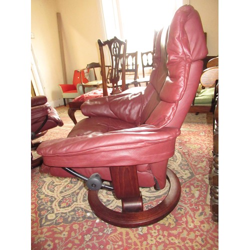 1855 - Stressless pair of burgundy leather upholstered tub chairs with foot stools