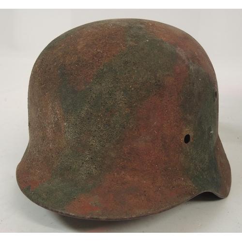 128 - Two German steel M40 pattern helmets, together with a similar helmet