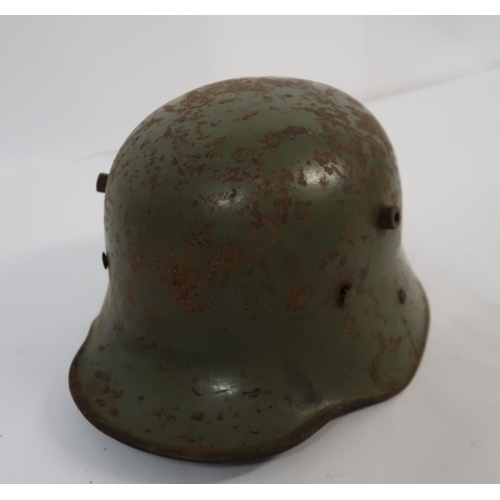 128 - Two German steel M40 pattern helmets, together with a similar helmet