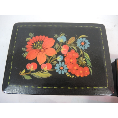 136 - Russian lacquer box painted with flowers, 15.5cm wide together with three other small Russian lacque... 