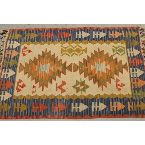 15 - Small Kelim rug with a twin medallion design on a beige ground with borders, 117 x 77cm