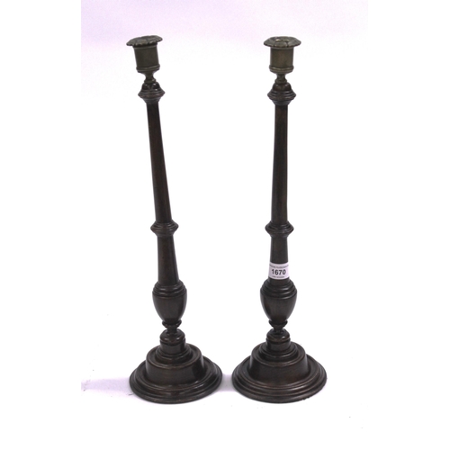 1670 - Pair of late 19th Century mahogany and brass mounted candlesticks in George III style, 46cm high