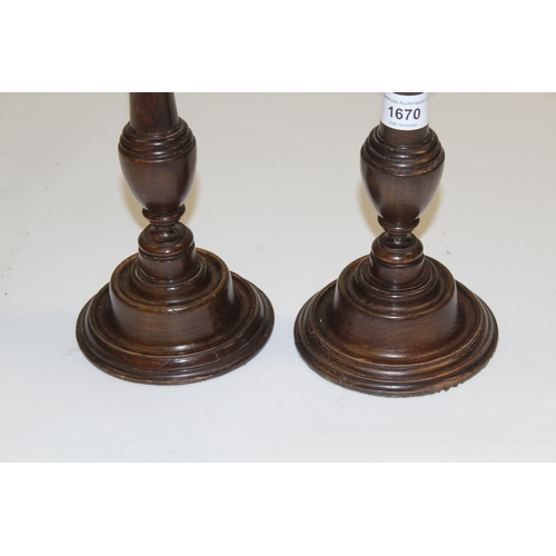 1670 - Pair of late 19th Century mahogany and brass mounted candlesticks in George III style, 46cm high