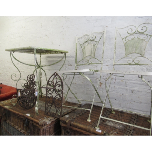 1672 - Cream painted wrought iron bistro type garden table with a pair of folding chairs, together with thr... 