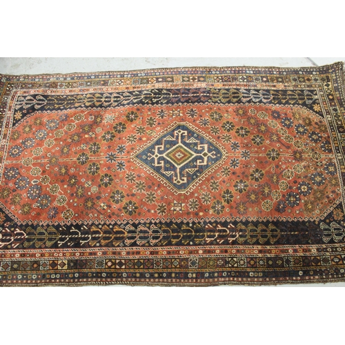 2 - Qashqai rug with a medallion and all-over stylised design on a red ground with borders, 200 x 125cm