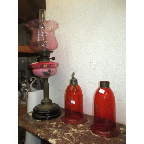 430 - 19th Century oil lamp having opaque pink floral painted well with pink tinted shade and a pair of or... 