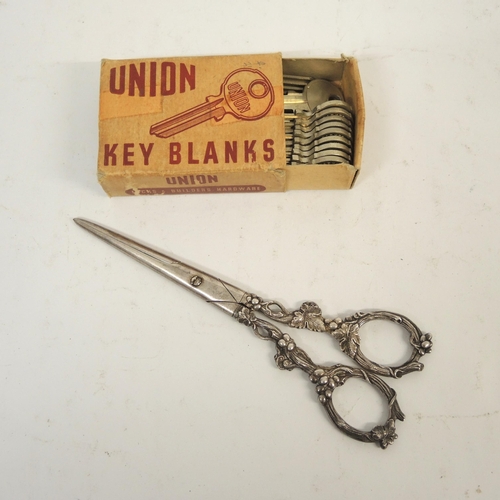 55 - Box of union key blanks and a pair of silver plated grape scissors with decorative handles