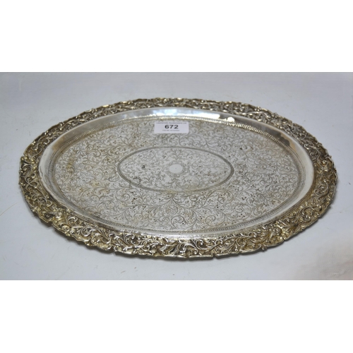 672 - Middle Eastern oval white metal tray, with engraved and cast decoration, 16oz t