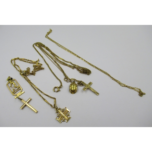 745 - Three various 9ct gold crosses with chains, another 9ct gold pendant and chain and an Egyptian style... 