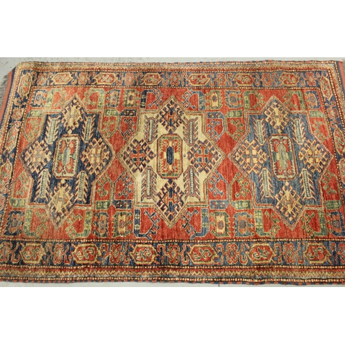 8 - Modern Turkish rug of Caucasian design with a triple medallion on a brick red ground with borders, 1... 