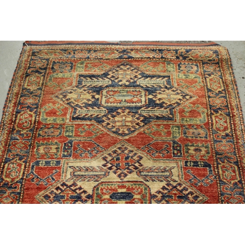 8 - Modern Turkish rug of Caucasian design with a triple medallion on a brick red ground with borders, 1... 