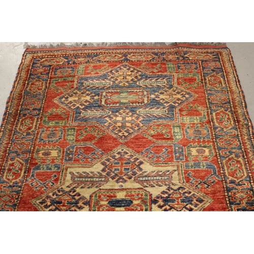 8 - Modern Turkish rug of Caucasian design with a triple medallion on a brick red ground with borders, 1... 