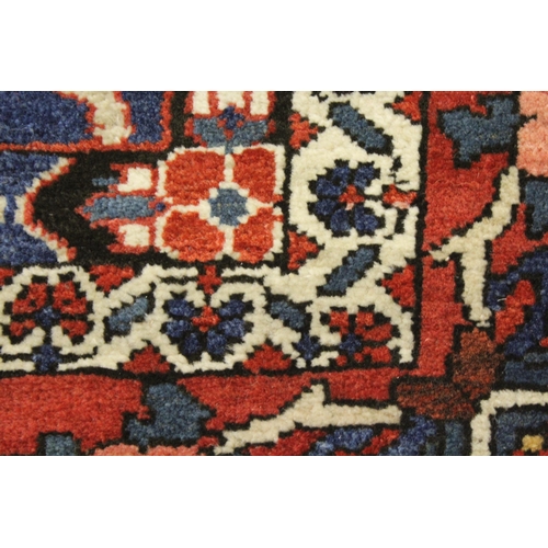 9 - Bakhtiari rug with a garden panel design in shades of red, blue and cream with borders, 202 x 135cm