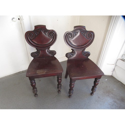 1681C - Pair of Victorian mahogany shield back hall chairs with panel seats on turned supports