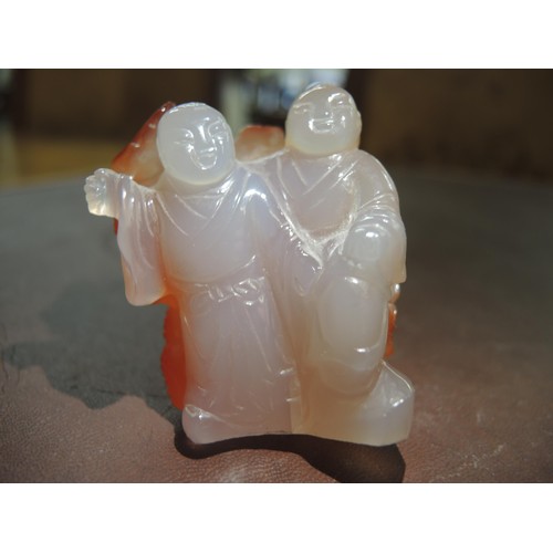 175 - Small Chinese carved jade group of two figures (at fault), together with a small Chinese hardwood bo... 