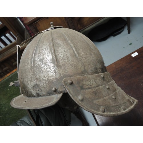 283 - 17th Century type lobster tail steel helmet, together with a similar steel breast plate