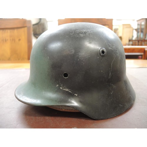 130 - Three various German M40 pattern steel helmets