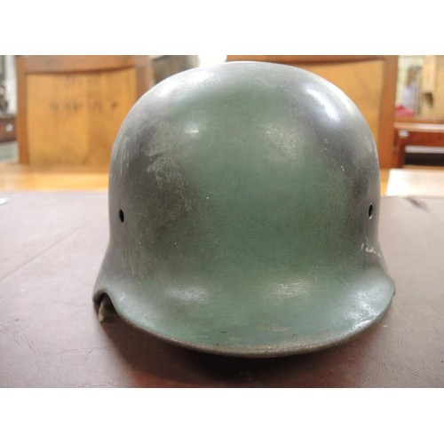 130 - Three various German M40 pattern steel helmets