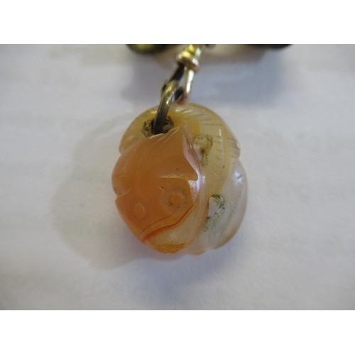 717 - Small carved jade pendant on a 9ct gold bow and clip