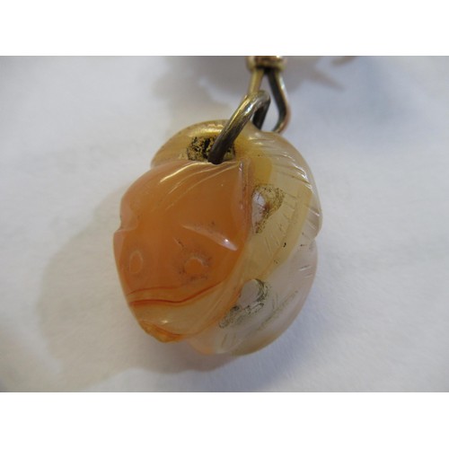 717 - Small carved jade pendant on a 9ct gold bow and clip