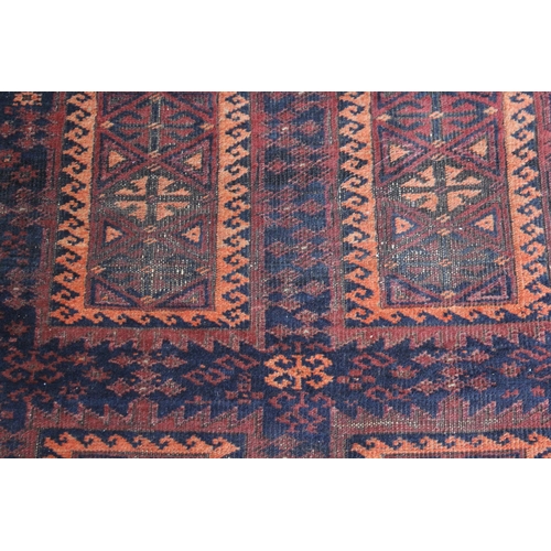 10 - Belouch rug with an eight panel design in shades of terracotta and dark blue, 200 x 116cm