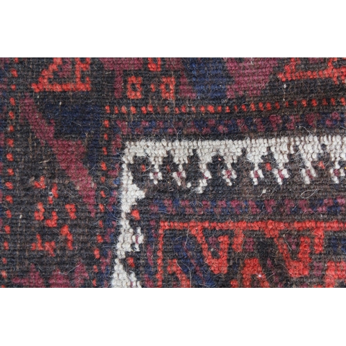 10 - Belouch rug with an eight panel design in shades of terracotta and dark blue, 200 x 116cm